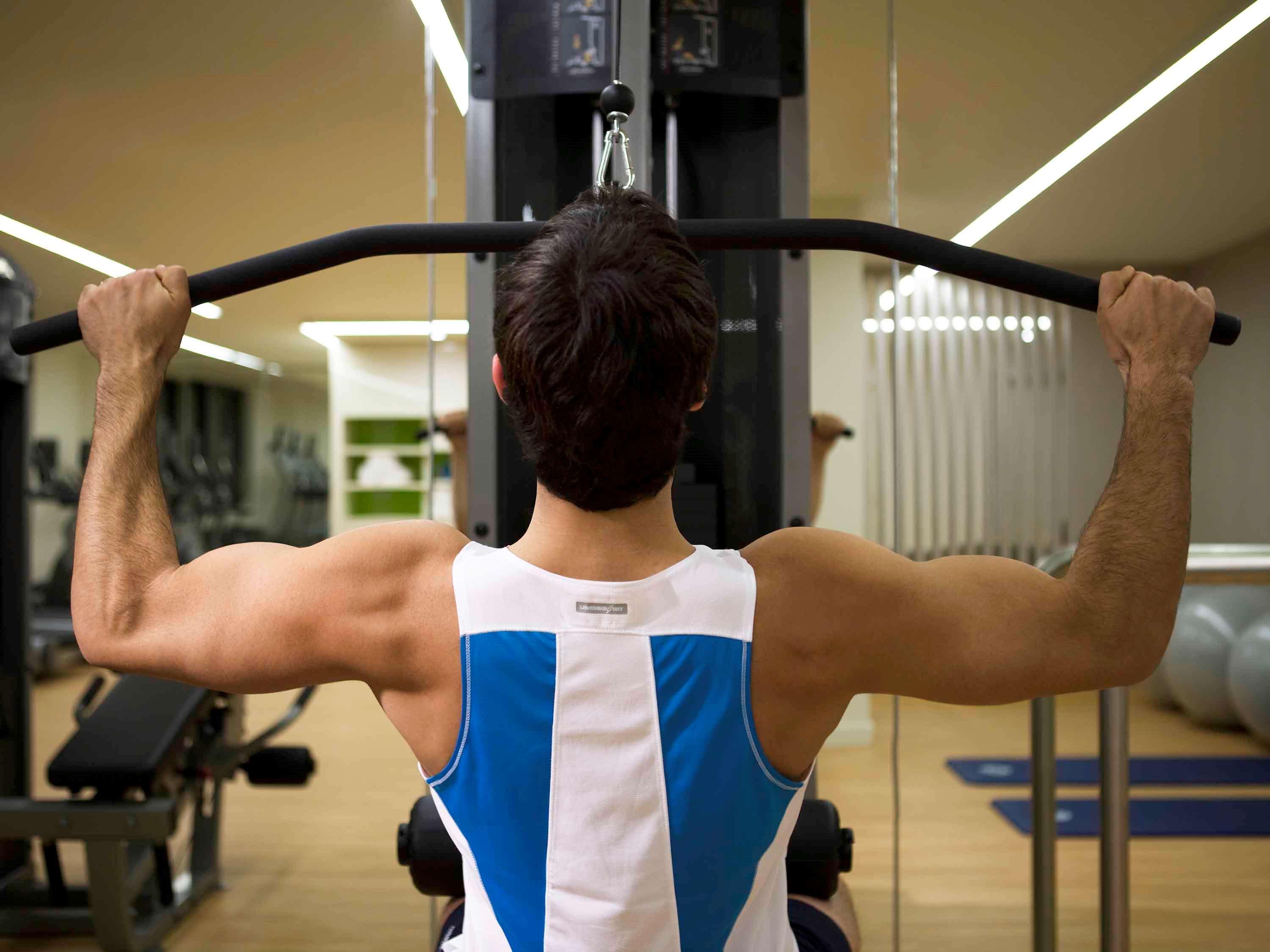 Pullman Sydney Olympic Park Hotel Exterior photo A man using a lat pulldown machine