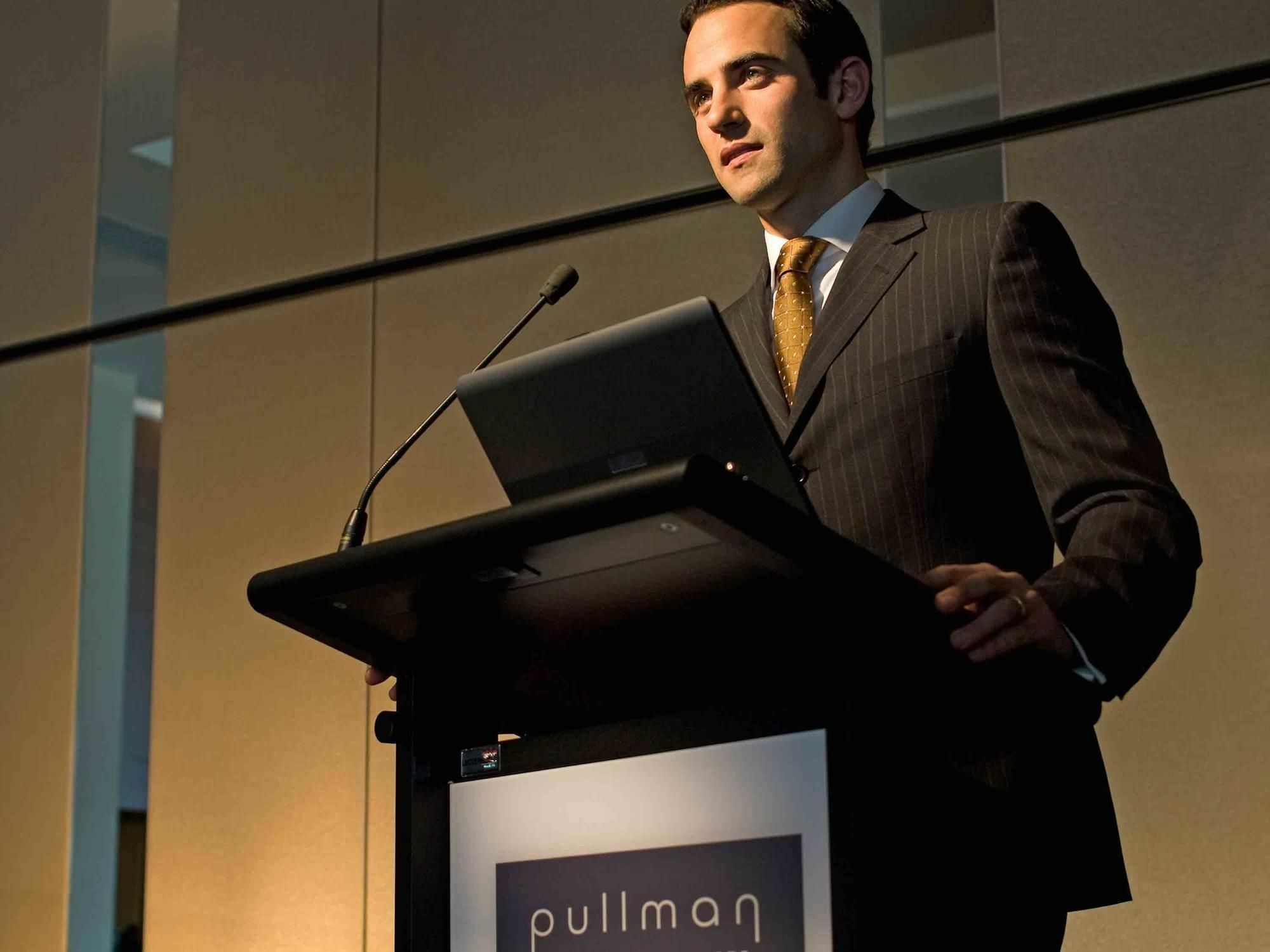 Pullman Sydney Olympic Park Hotel Exterior photo A man speaking at a podium